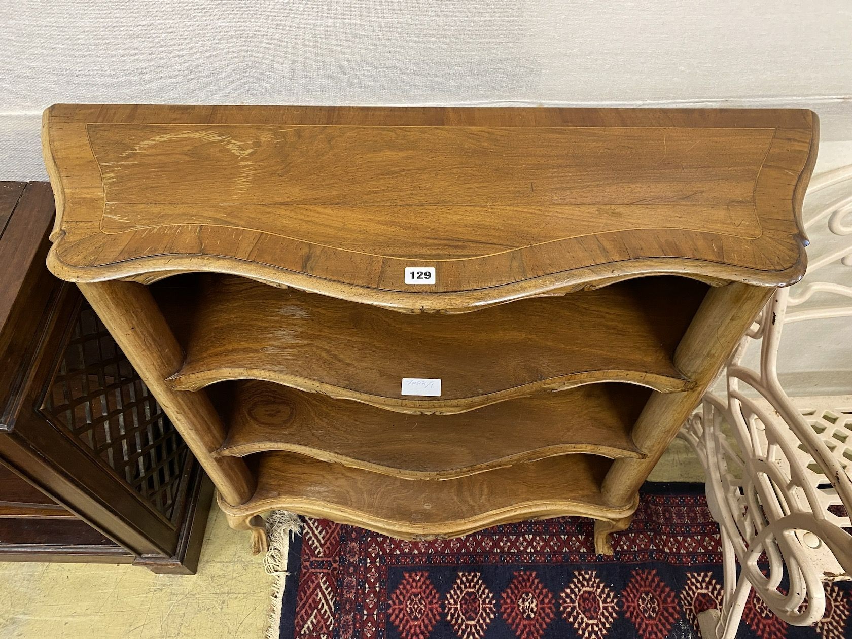 A reproduction Italian walnut serpentine open bookcase, length 98cm, depth 32cm, height 95cm